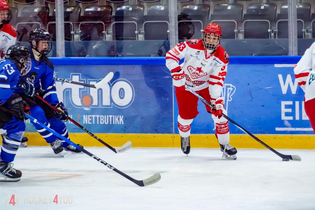 Timothy carrying the puck along the boards